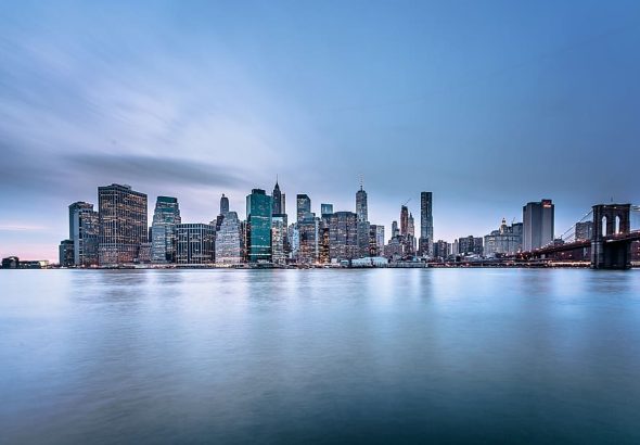 Panoramic view of a city skyline at dusk